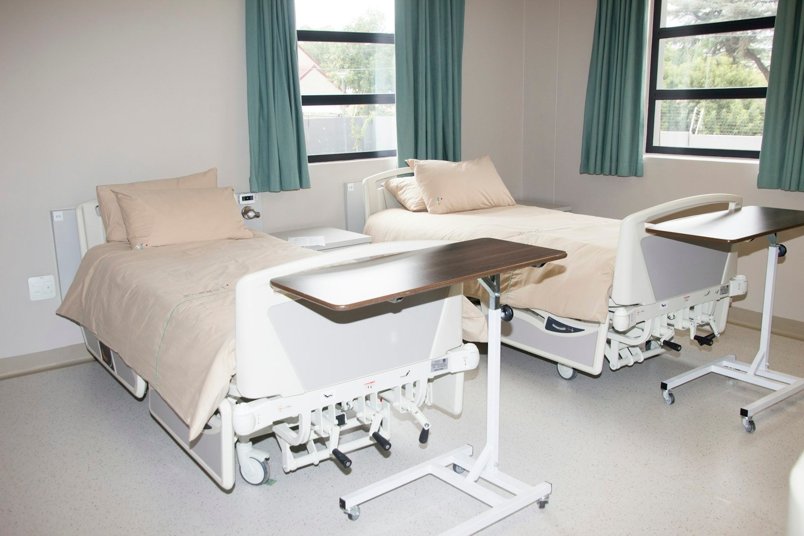 Empty hospital bed near a window